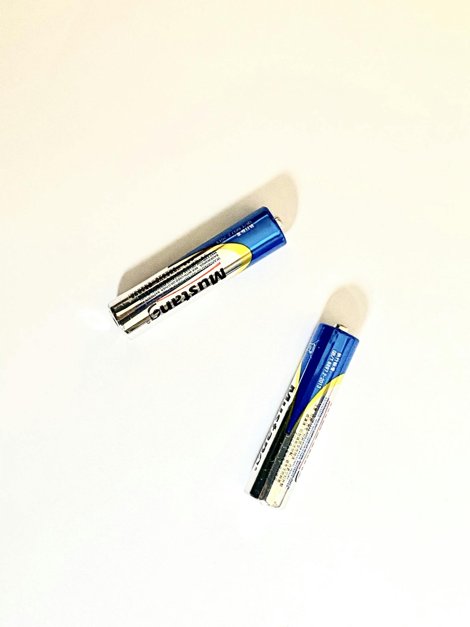 Two AA batteries arranged on a white background, perfect for power-related concepts.